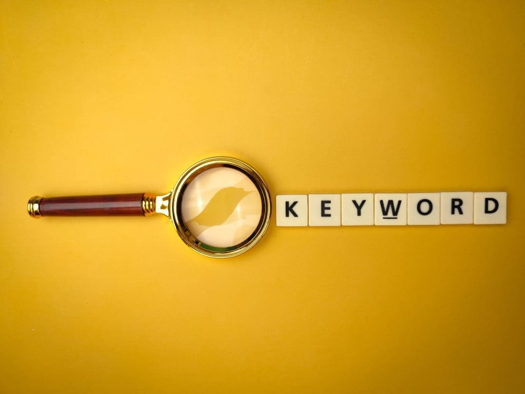 SEO keywords: How to choose and use them 1 Magnifying glass and toys word with the word KEYWORD on yellow background