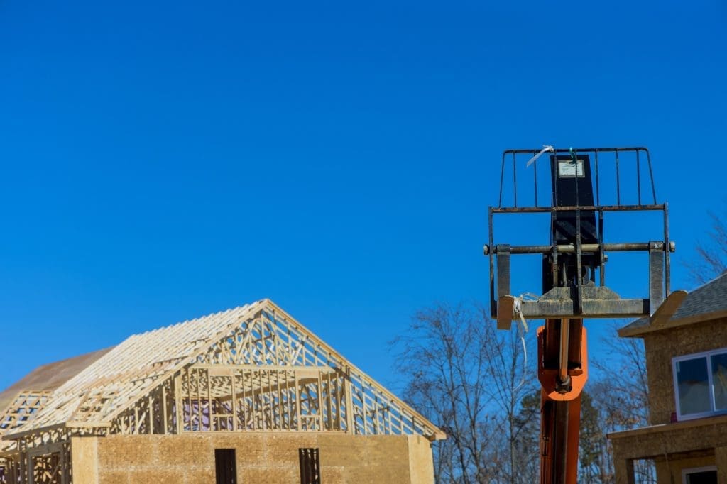 Powerful wheel forklift on a construction site, preparing to raise construction