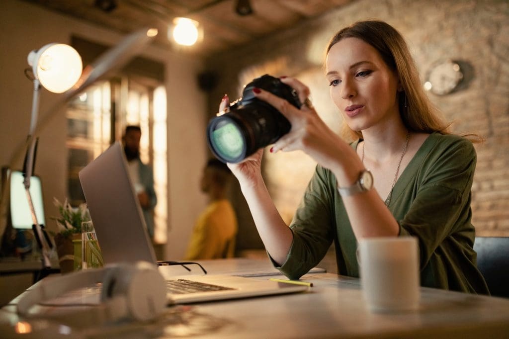 Our Free SEO Tools 1 Female photographer checking images on digital camera in a studio.